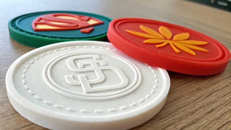 Close-up of an embossed and a screen-printed logo on silicone parts