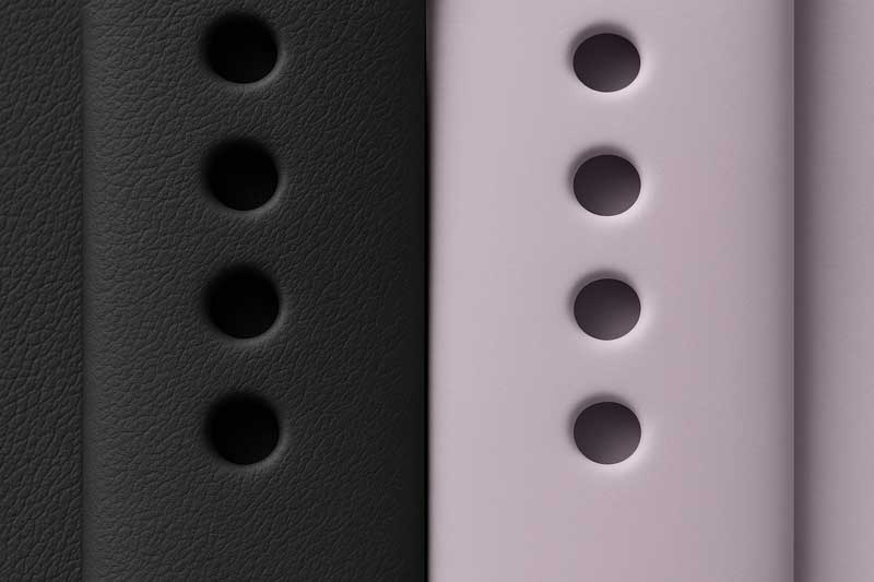 A close-up shot showing the texture of an Apple fluoroelastomer band next to a soft silicone band.