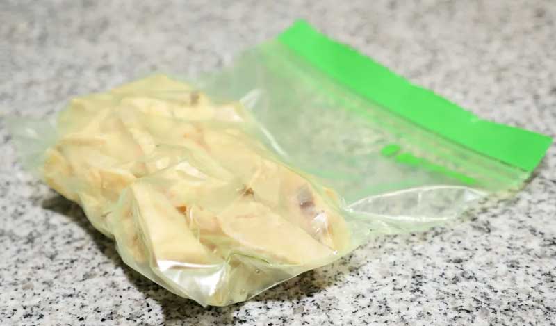A close-up shot showing the thick, airtight pinch-lock seal of a silicone freezer bag being closed.